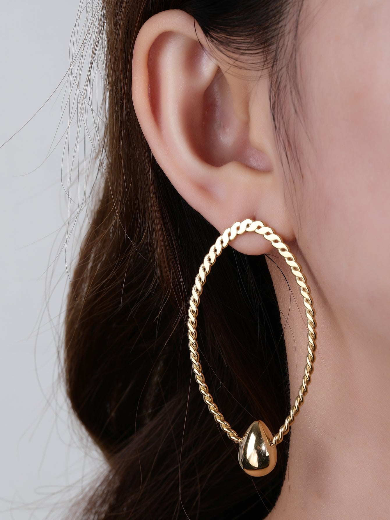 Golden Braided Oval Earrings With Teardrop